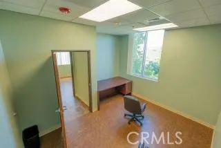 a view of a workspace with furniture and a chair