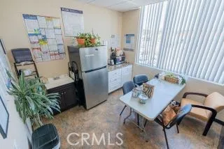a dining room with furniture and a window