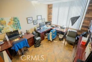 a view of a livingroom with workspace and a window