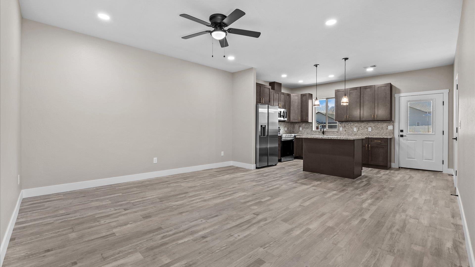 2642 B B 1/2 Road Grand Junction, CO 81503 - Photo 12 of 25 a view of kitchen with kitchen island stainless steel appliances cabinets and wooden floor