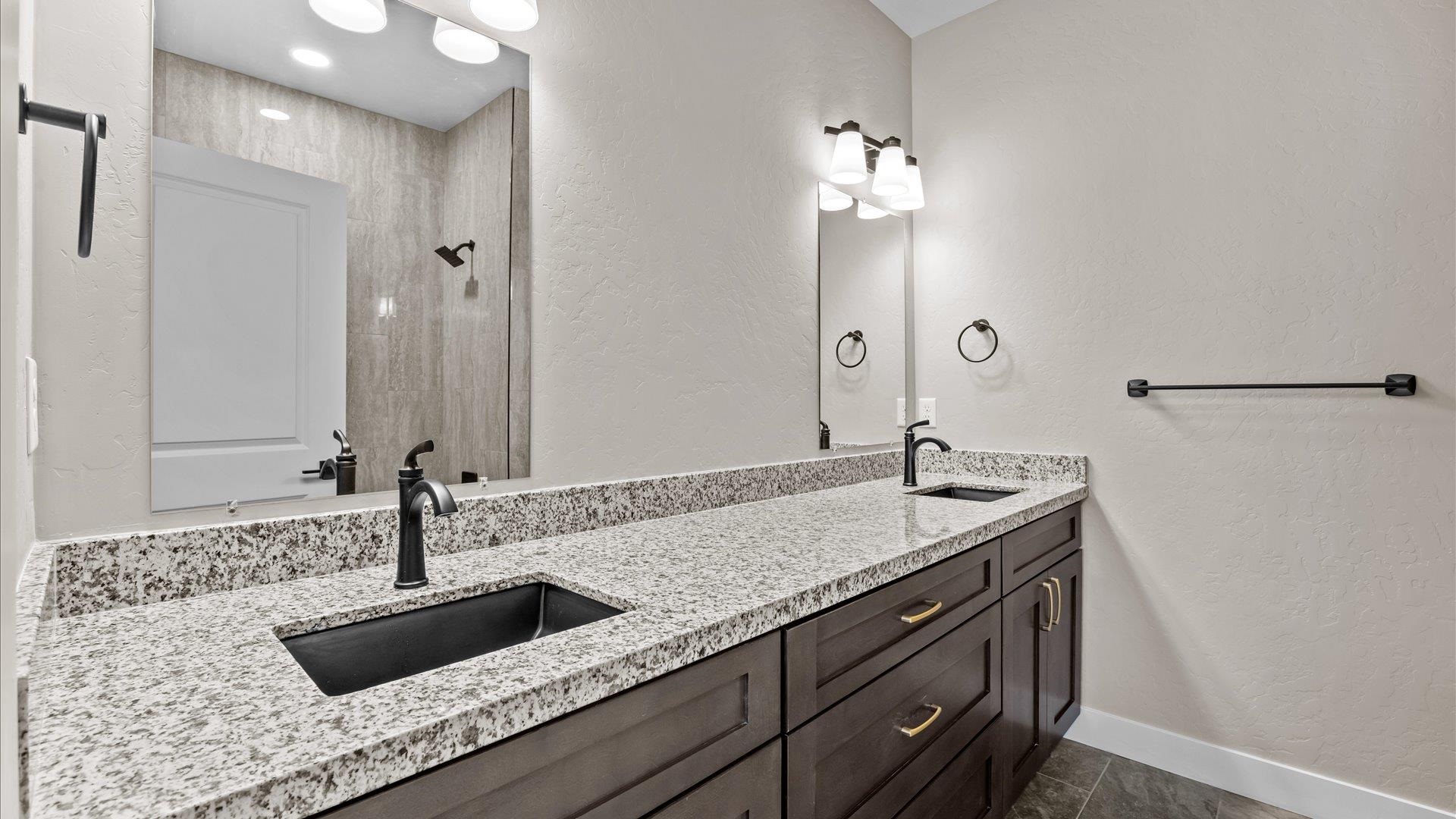 2642 B B 1/2 Road Grand Junction, CO 81503 - Photo 20 of 25 a bathroom with a granite countertop sink a mirror and shower