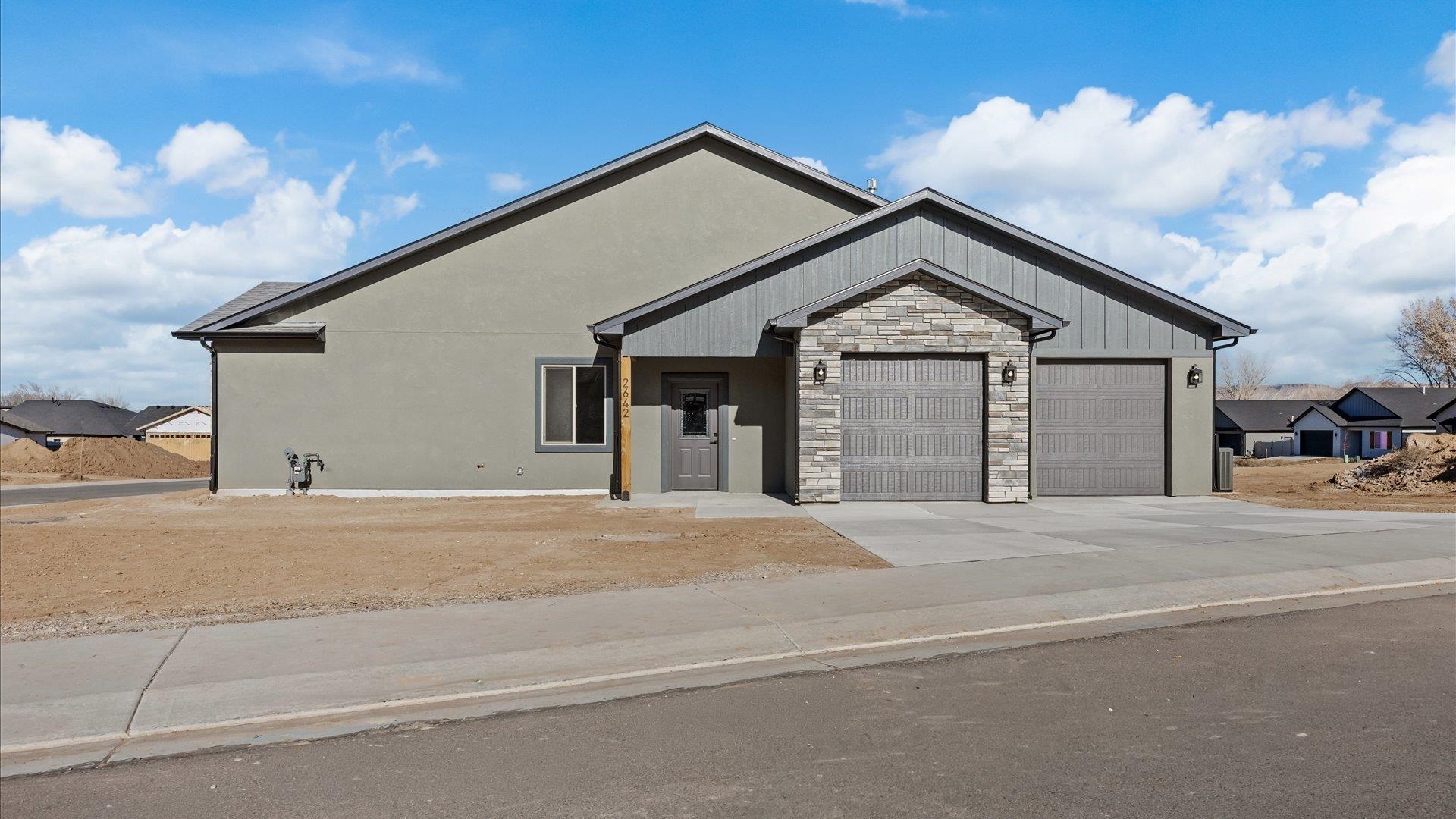 2642 B B 1/2 Road Grand Junction, CO 81503 - Photo 2 of 25 a front view of a house with a yard and garage