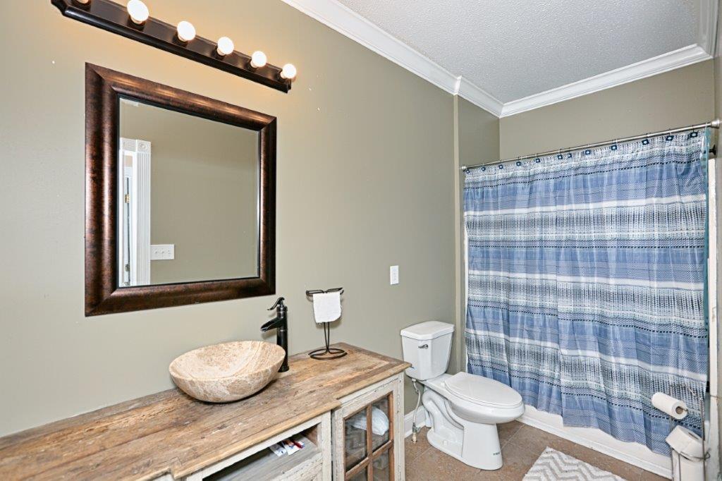 24 Henry Bayless Road Ardmore, TN 38449 - Photo 17 of 28 a bathroom with a toilet a sink and a mirror