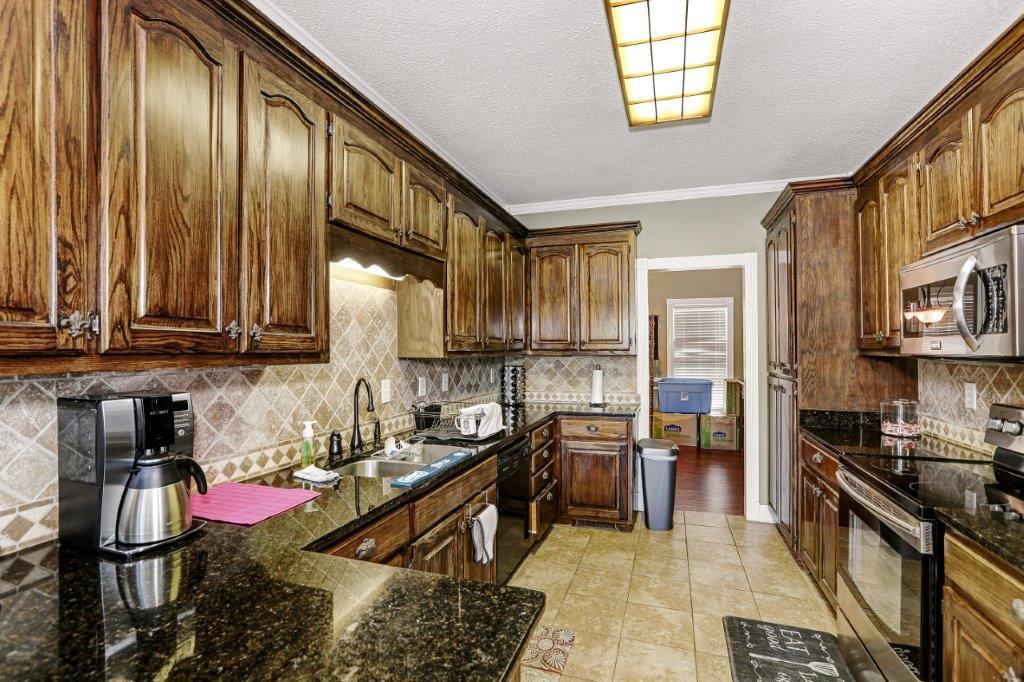 24 Henry Bayless Road Ardmore, TN 38449 - Photo 24 of 28 a kitchen with lots of appliances and cabinets