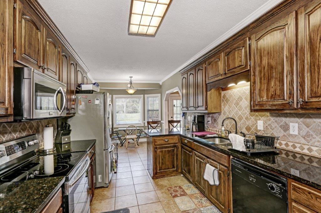 24 Henry Bayless Road Ardmore, TN 38449 - Photo 25 of 28 a kitchen with lots of counter top space a stove and cabinets