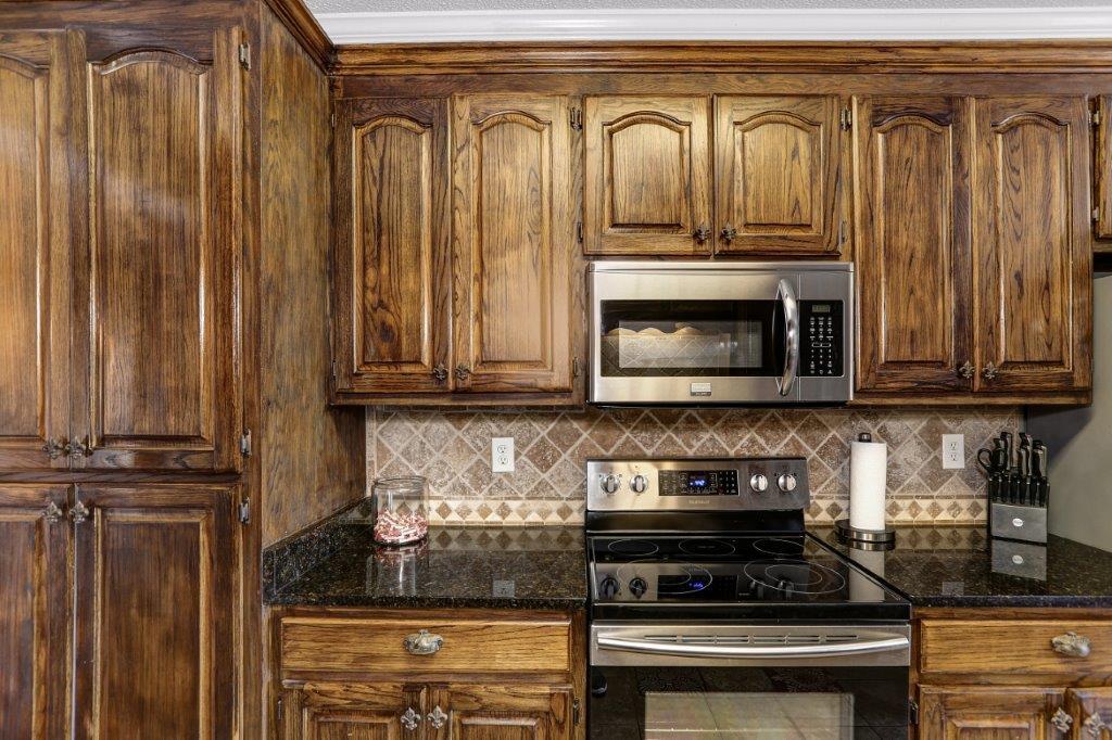 24 Henry Bayless Road Ardmore, TN 38449 - Photo 26 of 28 a kitchen with granite countertop a stove and a refrigerator
