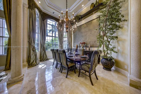 a view of a dining room with furniture and a chandelier