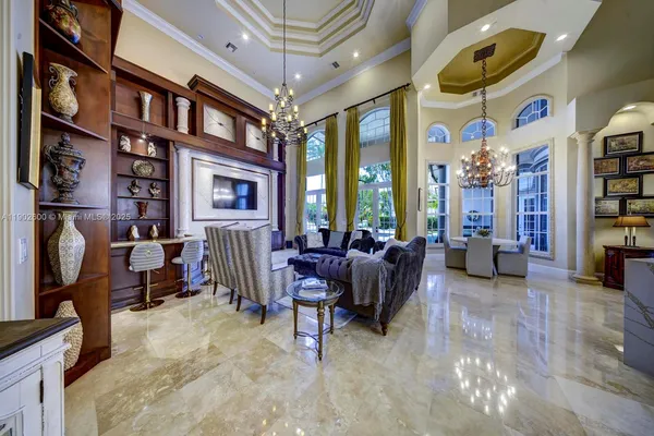 a living room with fireplace furniture and a chandelier