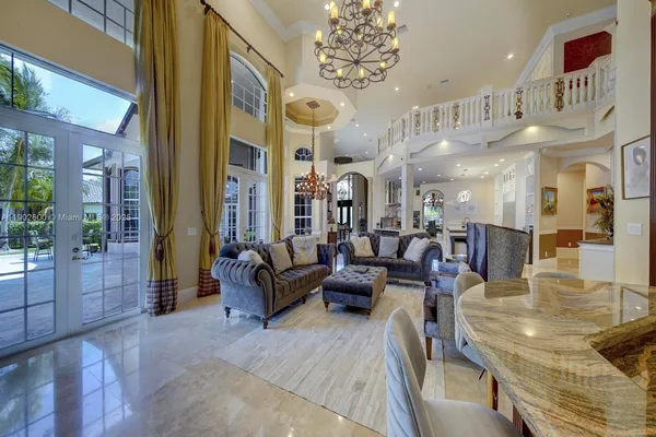 a living room with lots of furniture and a chandelier