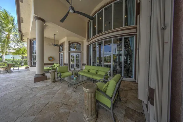 front view of a house with a chairs and table in a patio