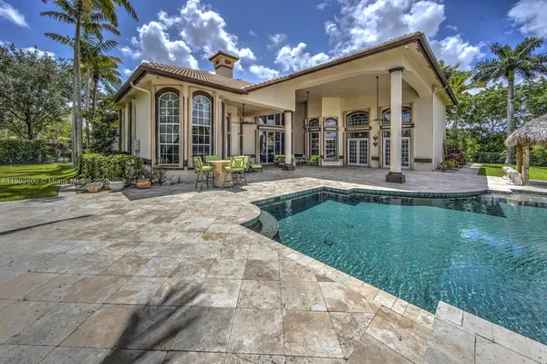 a view of a house with backyard and sitting area