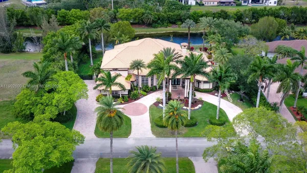 an aerial view of a house with garden space and lake view