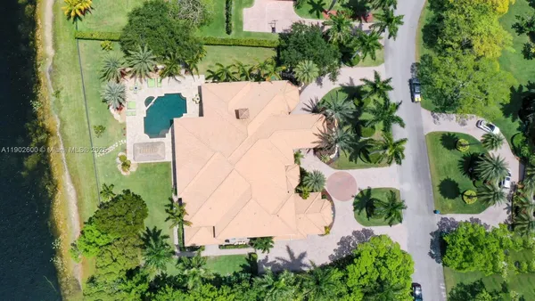 an aerial view of a house with a yard