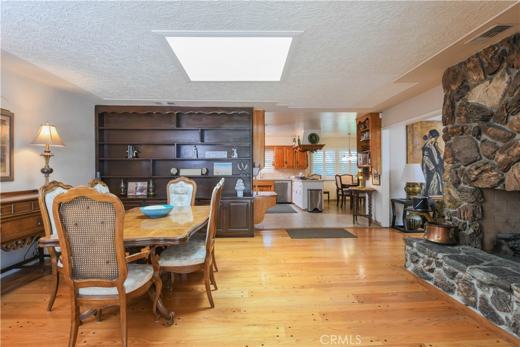 5382 Brighton Drive Riverside, CA 92504 - Photo 11 of 31 Formal dining area with fireplace and built-in cabinetry and bookcase