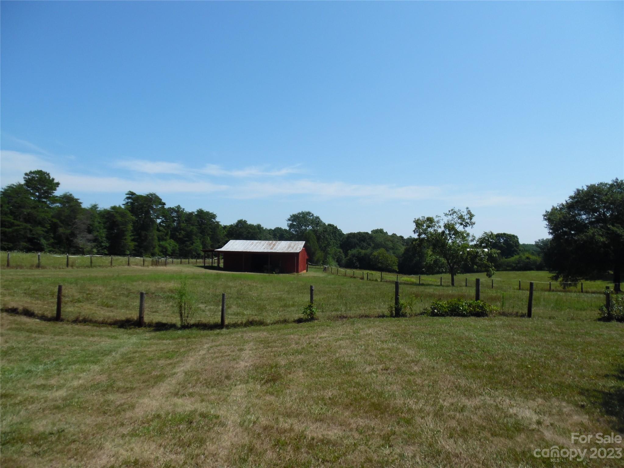 7728 Monbo Road Catawba, NC 28609 - Photo 17 of 39 a view of a green field with wooden fence