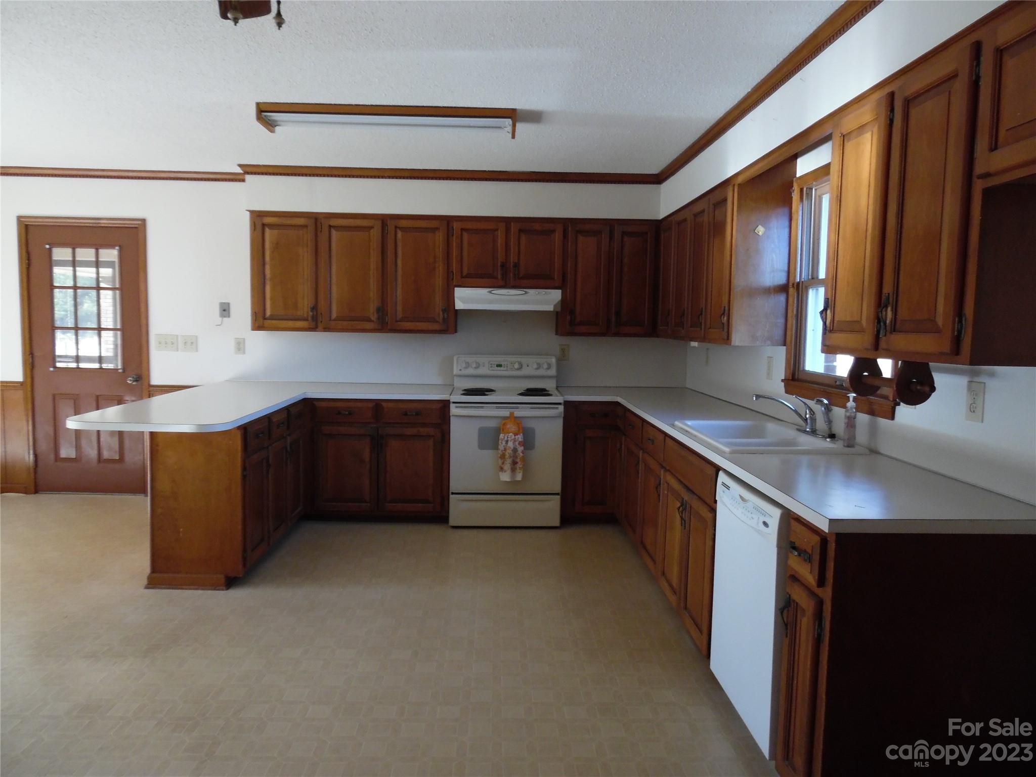 7728 Monbo Road Catawba, NC 28609 - Photo 23 of 39 a kitchen with stainless steel appliances granite countertop a sink stove cabinets and wooden floor