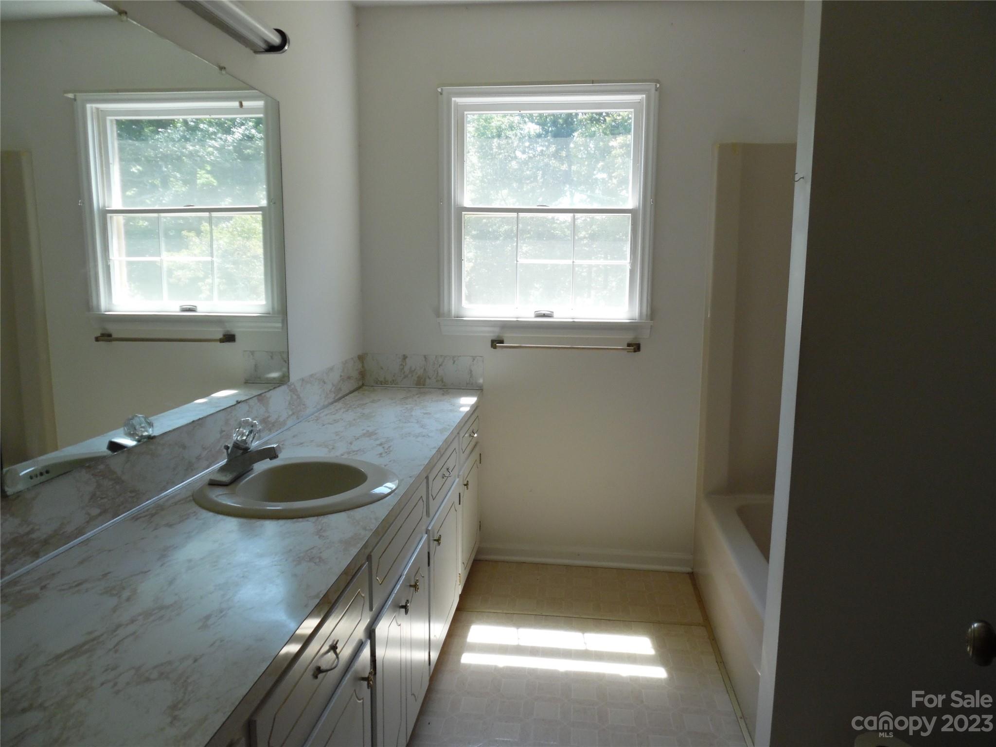 7728 Monbo Road Catawba, NC 28609 - Photo 29 of 39 a bathroom with a granite countertop sink and a window