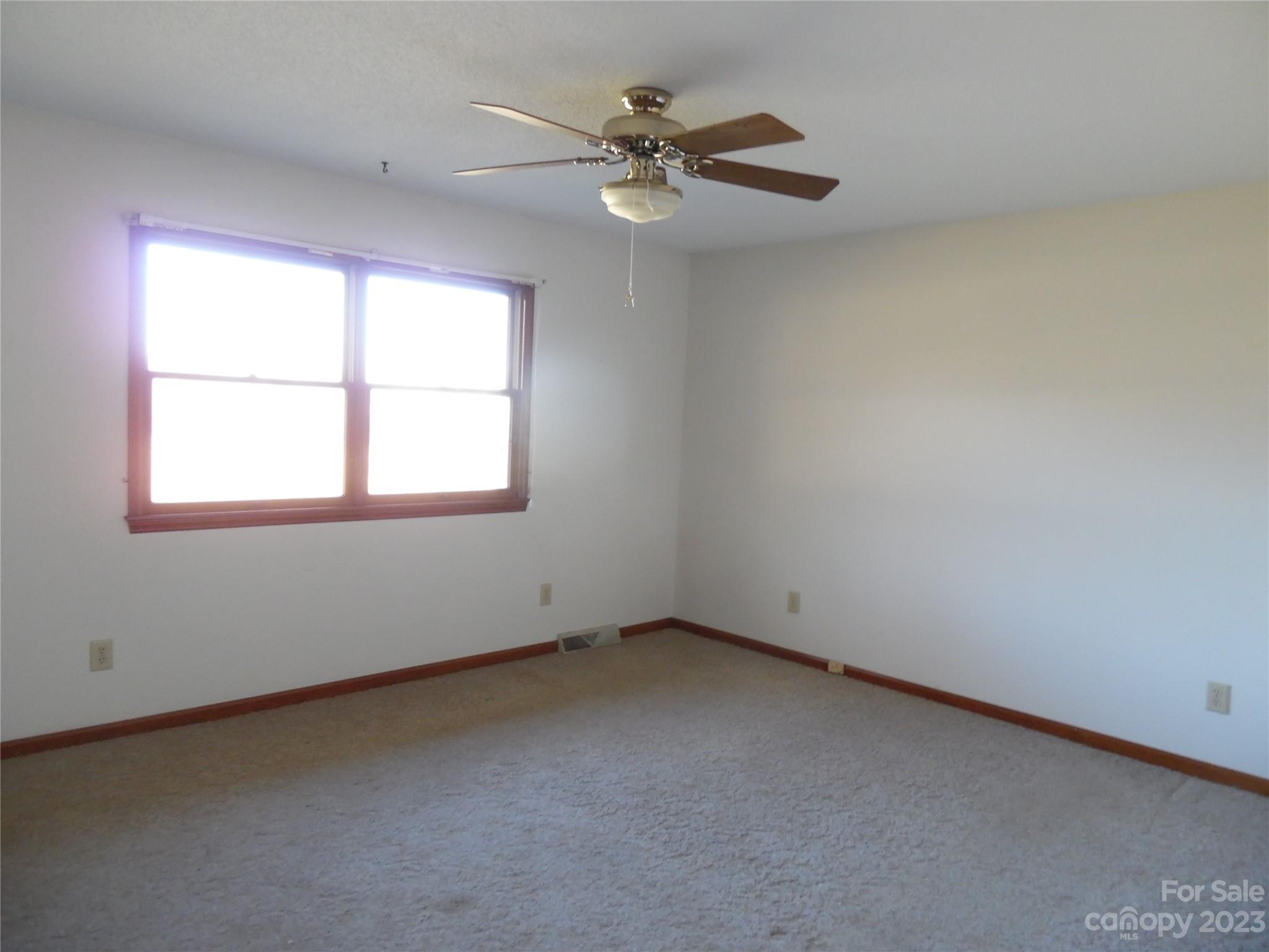 7728 Monbo Road Catawba, NC 28609 - Photo 32 of 39 an empty room with a window and a fan