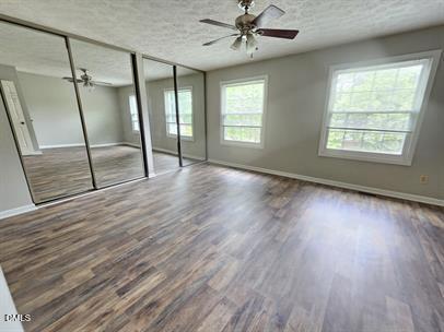 8184 McGuire Drive Raleigh, NC 27616 - Photo 13 of 13 a view of an empty room with wooden floor and window