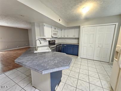 8184 McGuire Drive Raleigh, NC 27616 - Photo 4 of 13 a kitchen with stainless steel appliances granite countertop a stove a sink and a refrigerator