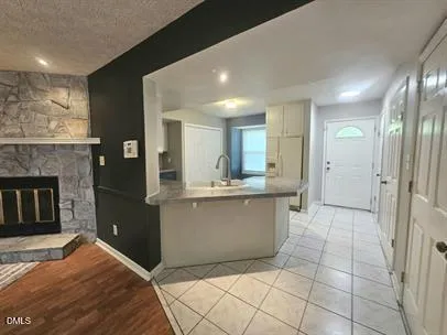 a kitchen with stainless steel appliances kitchen island granite countertop a refrigerator and a sink