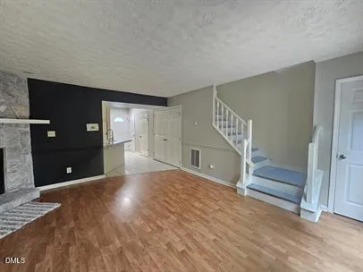 a view of entryway with wooden floor and stairs