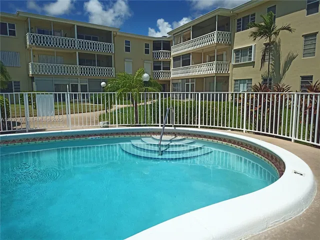 a terrace with wooden bench and potted plants
