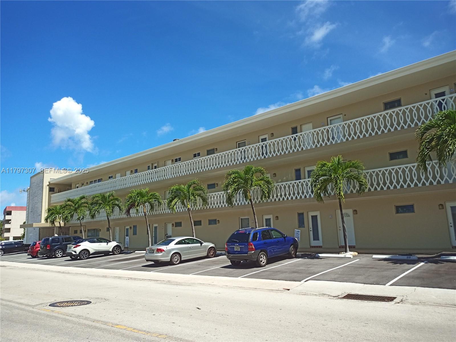 450 Golden Isles Drive, Unit 2H Hallandale Beach, FL 33009 - Photo 19 of 24 a view of a parking area