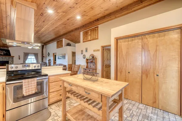 a kitchen with a stove a sink and a refrigerator