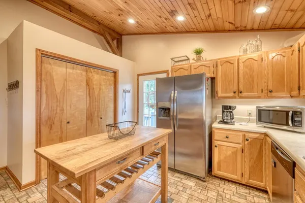 a kitchen with stainless steel appliances granite countertop a refrigerator a sink and a stove