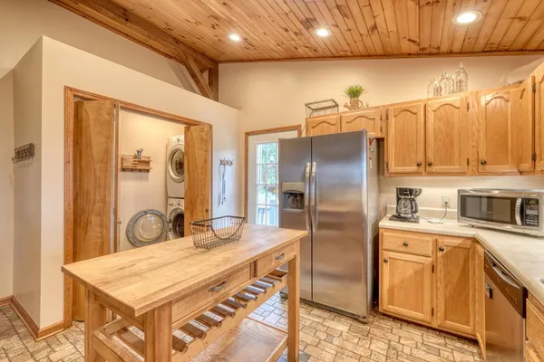 a kitchen with stainless steel appliances a refrigerator and sink