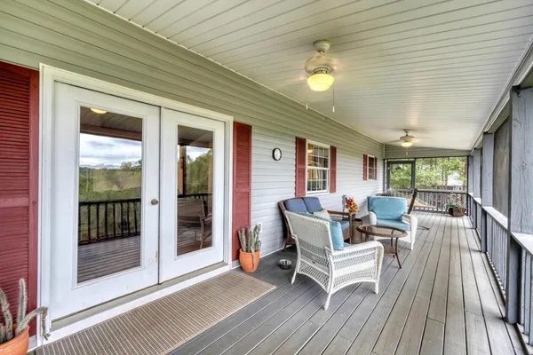 a balcony with furniture and wooden floor