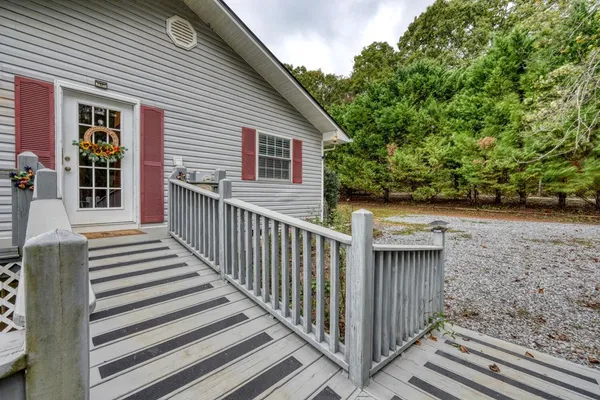 a view of a porch with wooden floor and fence