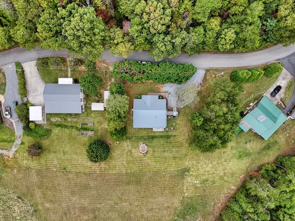 an aerial view of a house with a yard