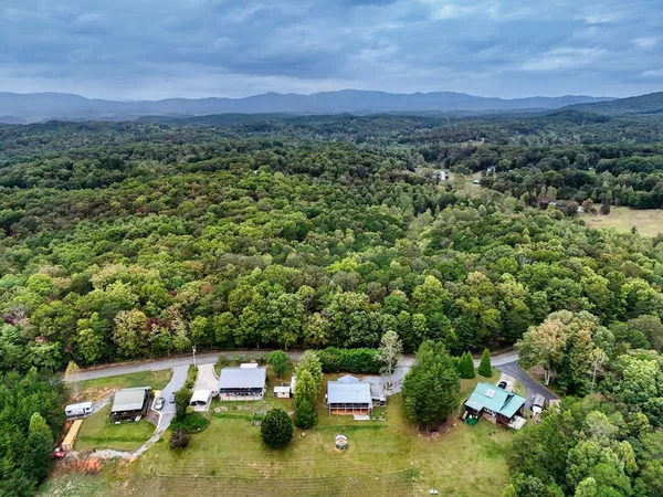 an aerial view of a houses with a yard