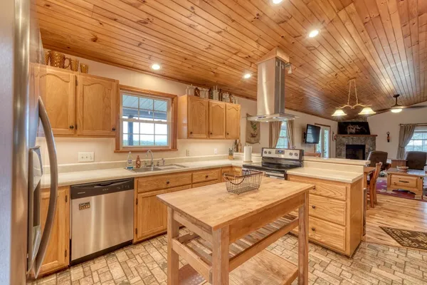 a kitchen with a stove a sink and a refrigerator