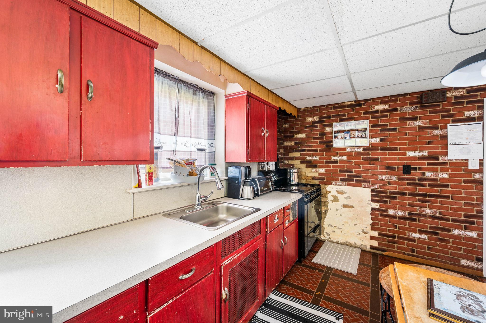 413 Maplewood Road Springfield, PA 19064 - Photo 10 of 21 a kitchen with a sink stove and cabinets