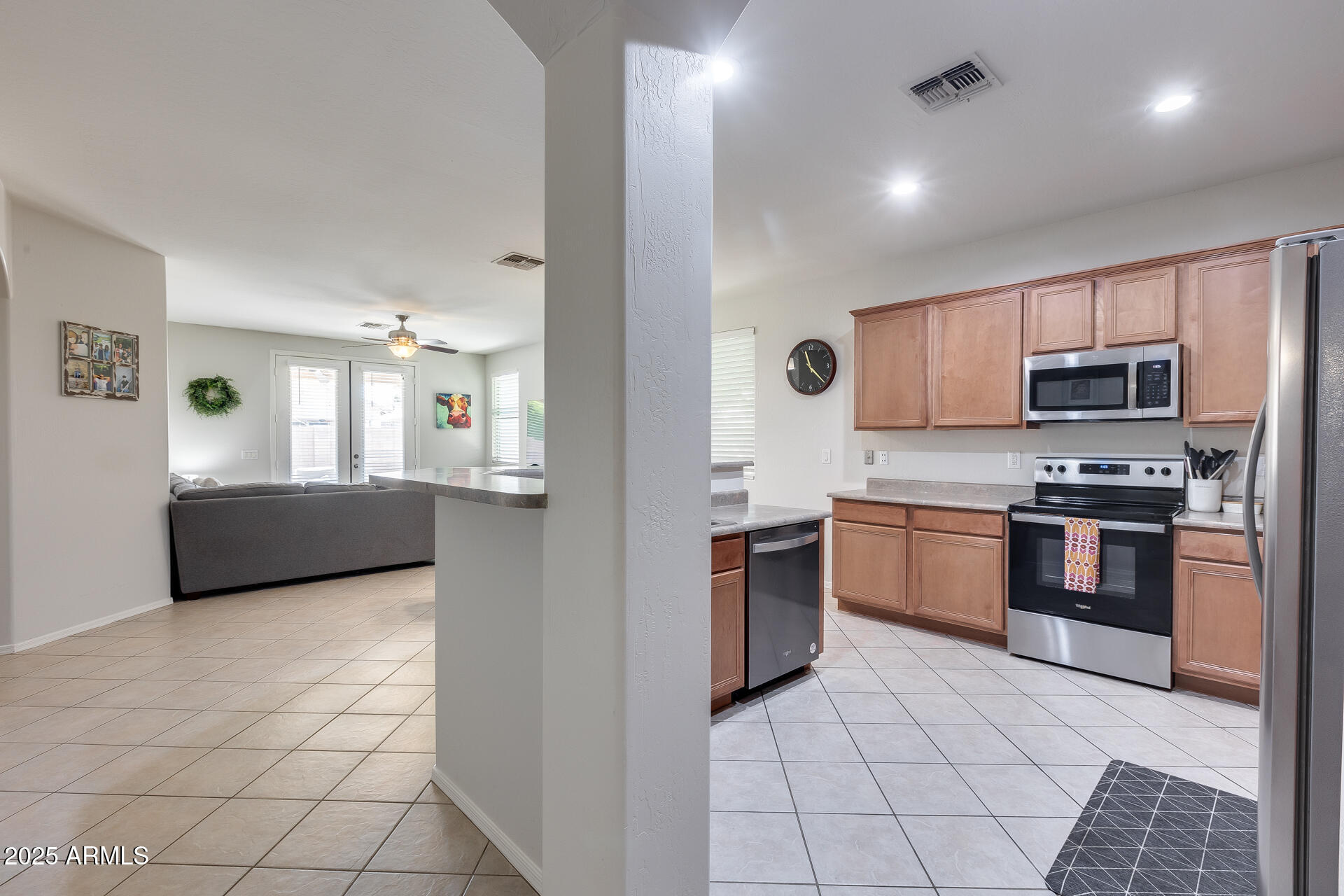 14229 West Calavar Road Surprise, AZ 85379 - Photo 10 of 44 a kitchen with granite countertop a stove a sink and a refrigerator