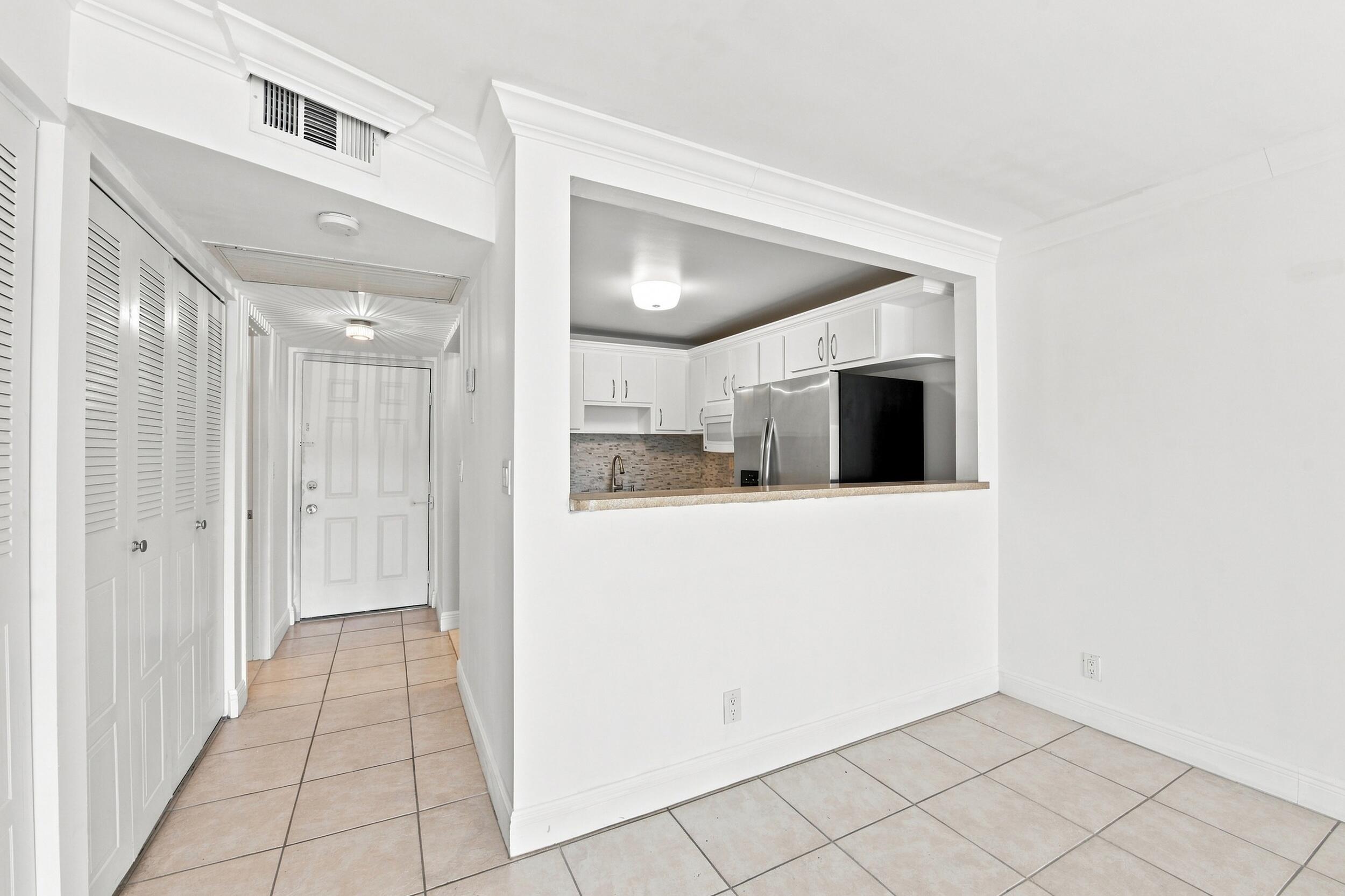 9300 Southwest 8th Street, Unit 219 Boca Raton, FL 33428 - Photo 2 of 26 Foyer into dinning area
