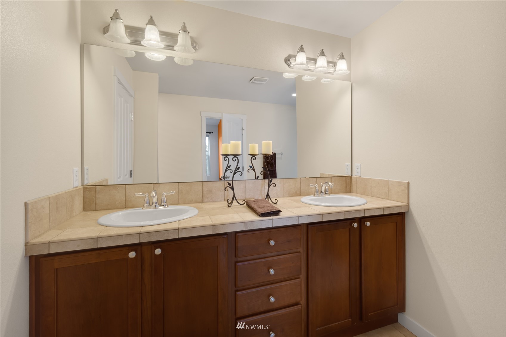 3712 224th Street Southeast Bothell, WA 98021 - Photo 20 of 24 a bathroom with a granite countertop sink a large mirror and vanity