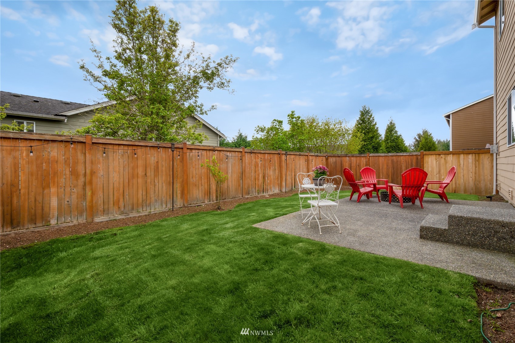 3712 224th Street Southeast Bothell, WA 98021 - Photo 24 of 24 a backyard of a house with table and chairs