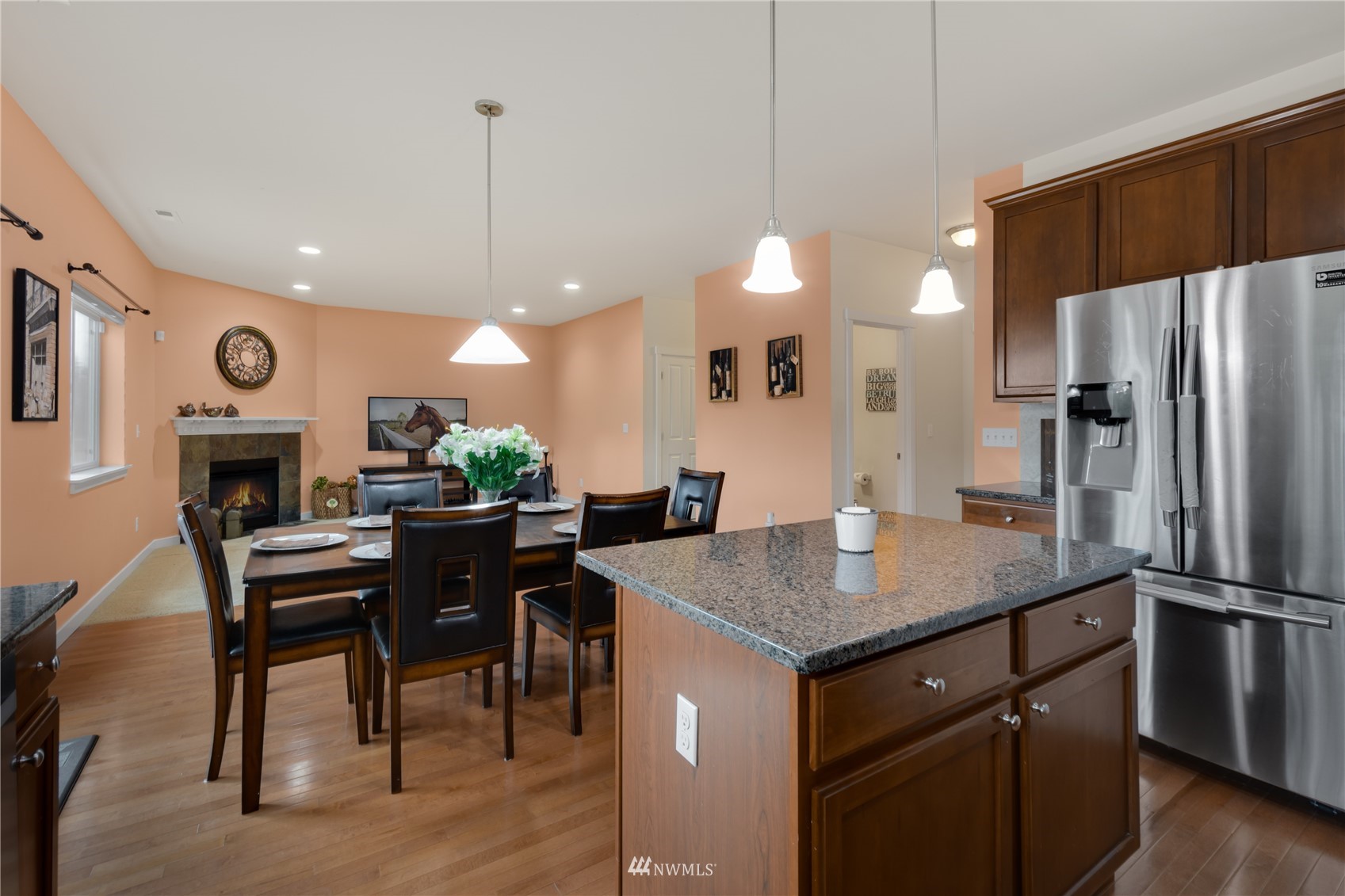 3712 224th Street Southeast Bothell, WA 98021 - Photo 7 of 24 a kitchen with a table chairs refrigerator and microwave