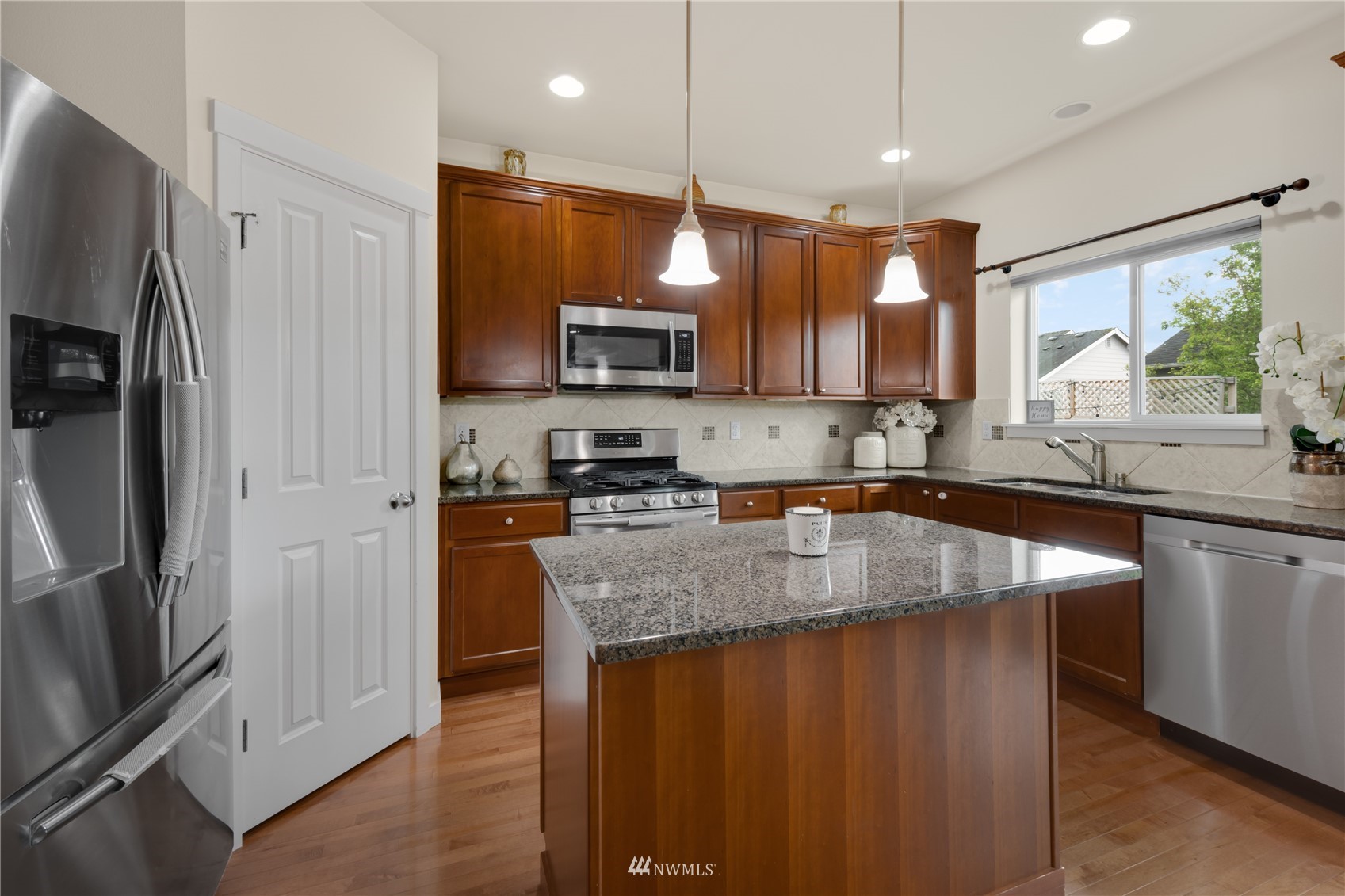 3712 224th Street Southeast Bothell, WA 98021 - Photo 9 of 24 a kitchen with stainless steel appliances granite countertop a refrigerator a sink and a stove