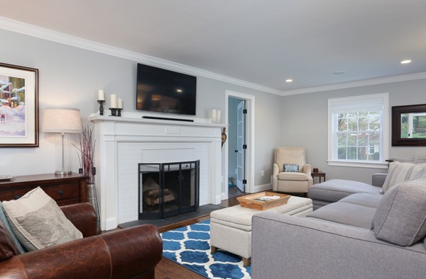 31 Buswell Park Newton, MA 02458 - Photo 2 of 20 a living room with furniture a fireplace and a flat screen tv