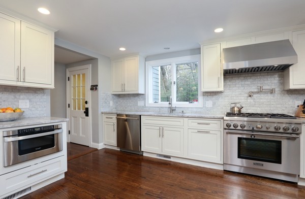 31 Buswell Park Newton, MA 02458 - Photo 3 of 20 a kitchen with granite countertop wooden floor stainless steel appliances and white cabinets