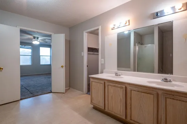 a bathroom with a double vanity sink and a mirror