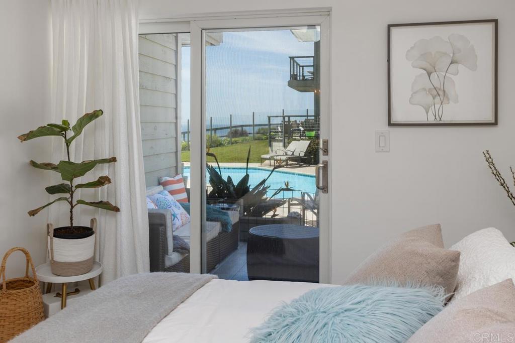 940 Sealane Drive, Unit 3 Encinitas, CA 92024 - Photo 18 of 29 a bedroom with a bed and a potted plant