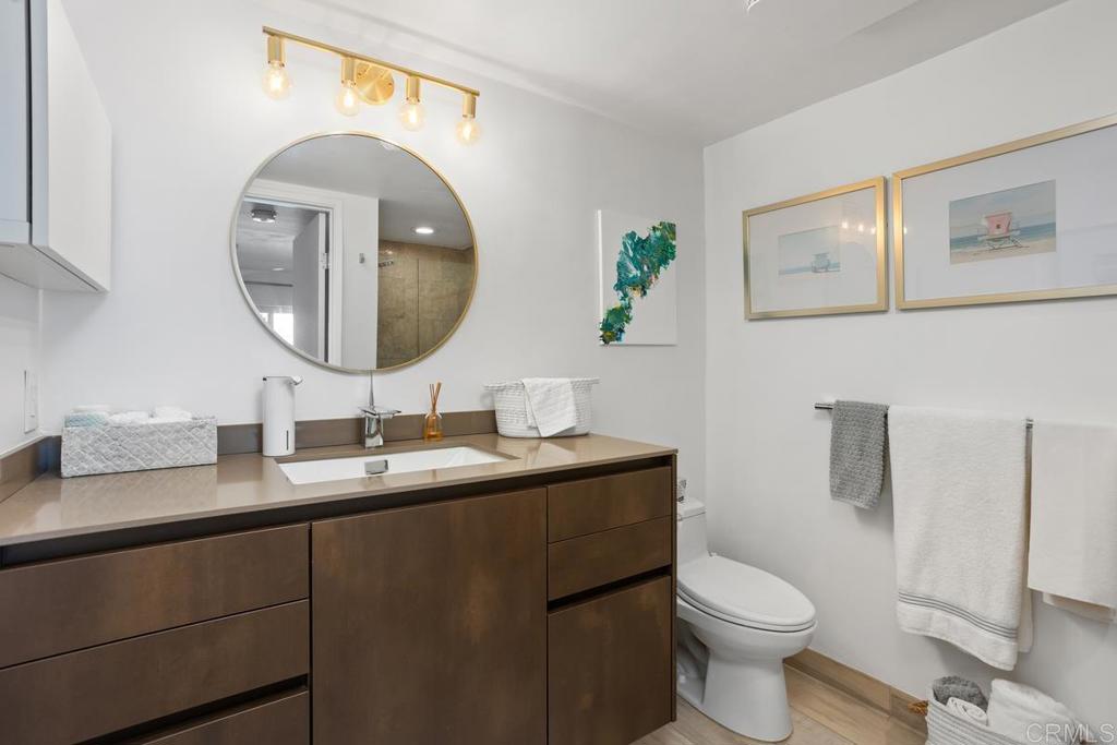 940 Sealane Drive, Unit 3 Encinitas, CA 92024 - Photo 20 of 29 a bathroom with a toilet a sink and mirror