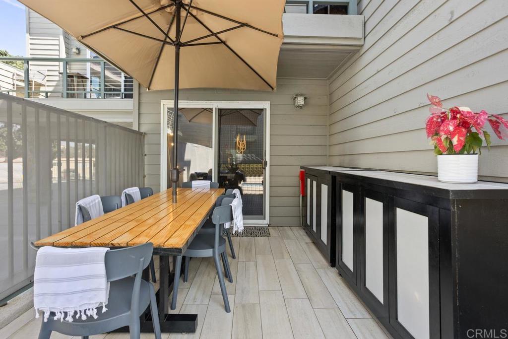 940 Sealane Drive, Unit 3 Encinitas, CA 92024 - Photo 24 of 29 a view of a patio with a table and chairs under an umbrella