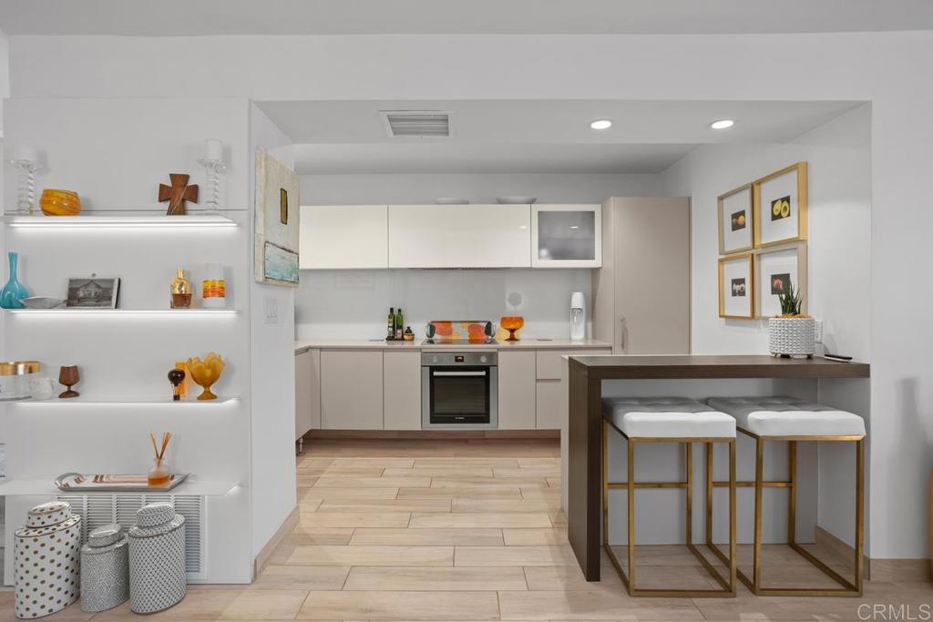 940 Sealane Drive, Unit 3 Encinitas, CA 92024 - Photo 10 of 29 a kitchen with a stove and white cabinets